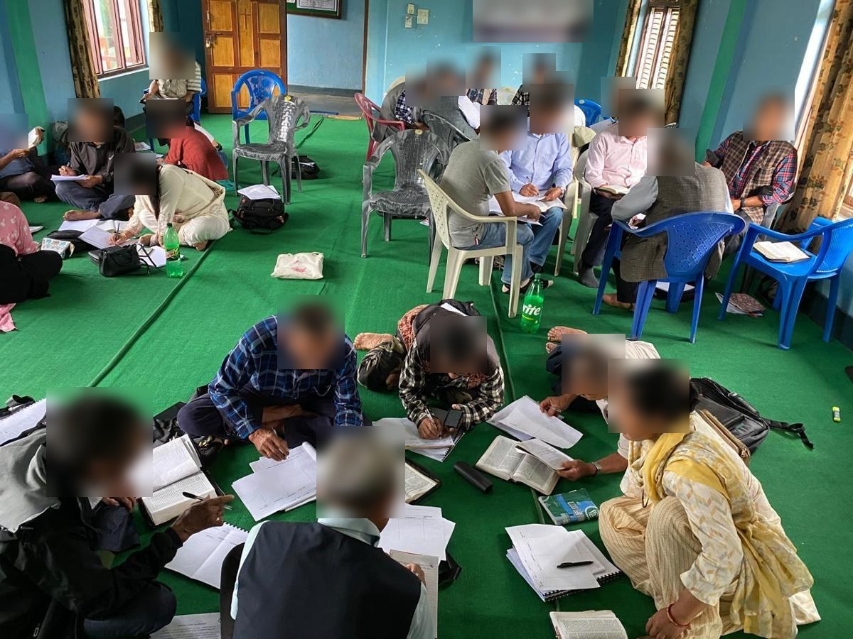 Church leaders studying the Bible together at a training workshop